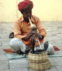 OBAMA, THE SNAKE CHARMER,